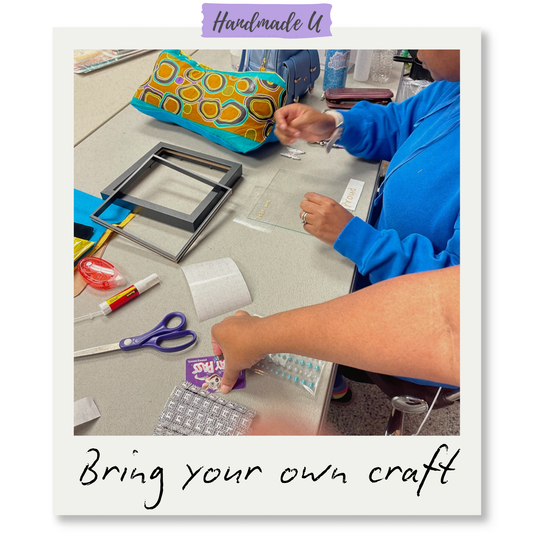 Person working on a craft project with various materials on a table, featuring Handmade U branding.
