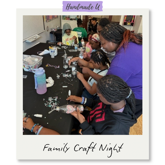 Group of people at a table participating in a craft activity during a Family Craft Night event.